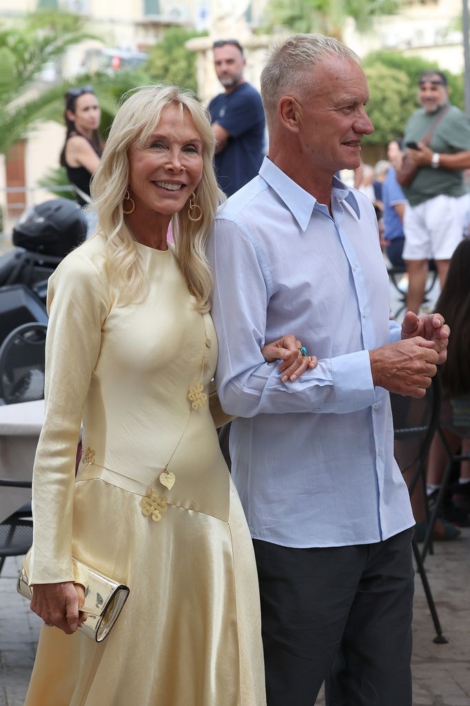 Trudie in yellow dress holding arm of sting