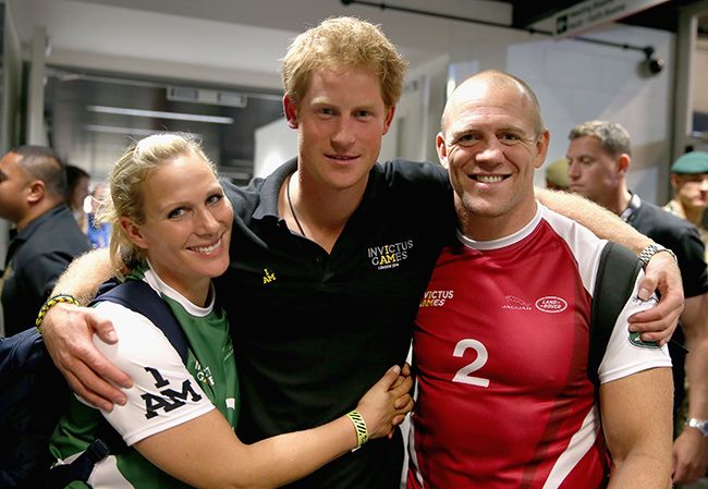 Zara and Mike hugging Prince Harry in 2014