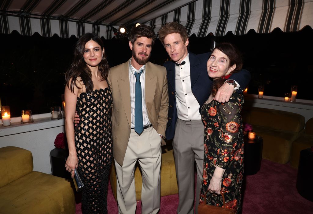 Monica Barbaro, Andrew Garfield, Eddie Redmayne and Lynn Hirschberg standing together