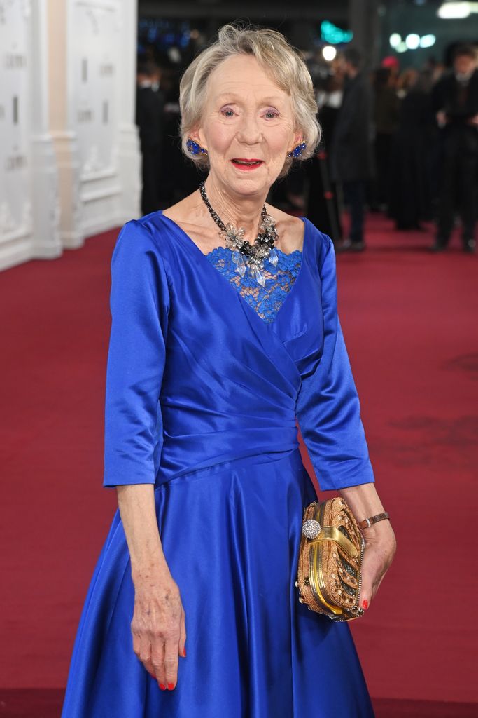 Marcia Warren in a blue dress
