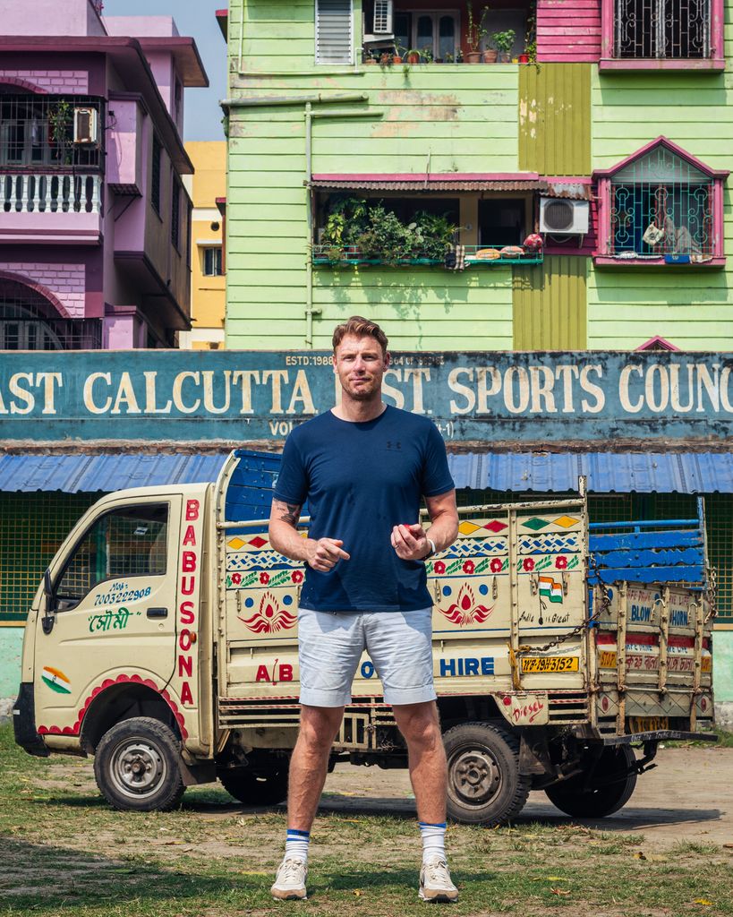 Freddie Flintoff in a blue shirt and shorts holding a cricket ball