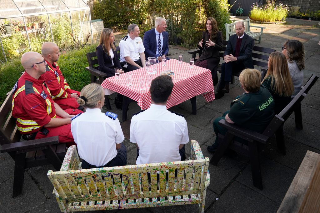 Prince William, Prince of Wales and Britain's Catherine, Princess of Wales speak to members of the emergency services during a visit to Southport Community Centre 