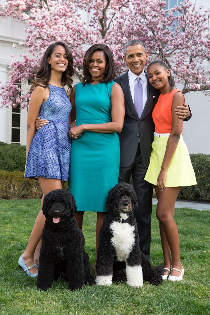President Barack Obama, First Lady Michelle Obama, and daughters Malia (L) and Sasha (R) pose for a family portrait with their pets Bo and Sunny in the Rose Garden of the White House on Easter Sunday, April 5, 2015