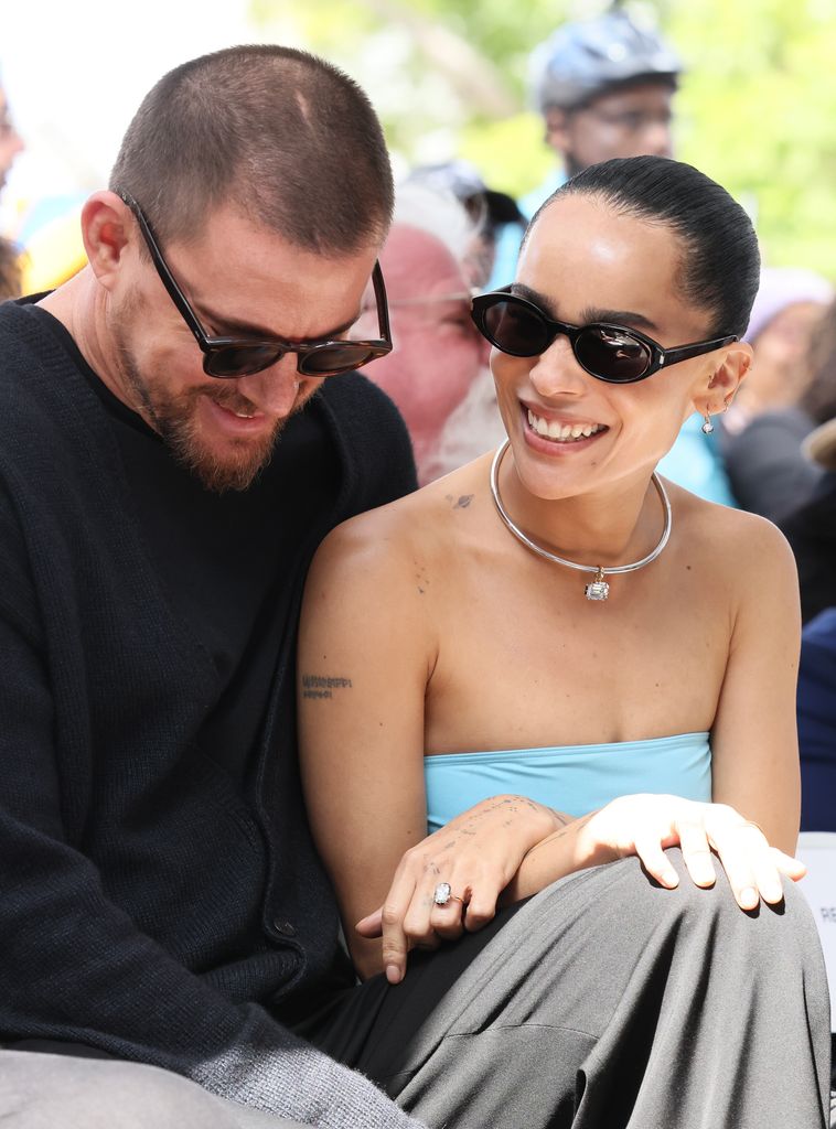 Channing Tatum in sunglasses sitting next to Zoe Kravitz