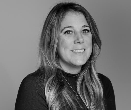 black and white headshot of a smiling woman