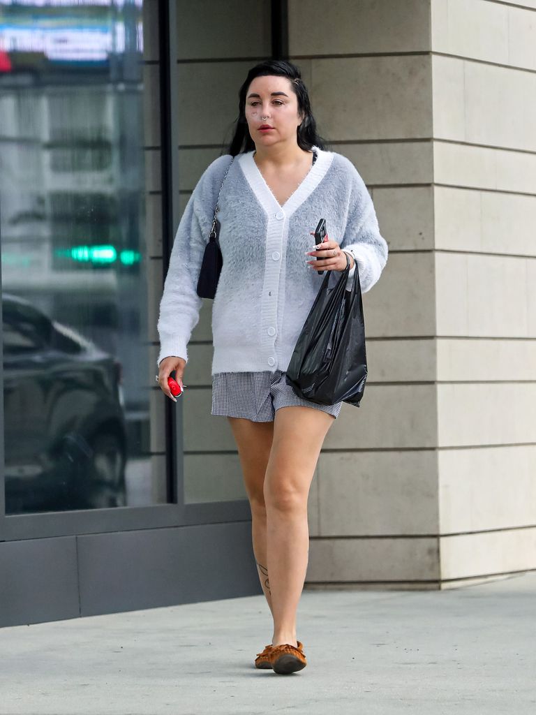 Amanda Bynes walking in LA in a cardigan and mini skirt