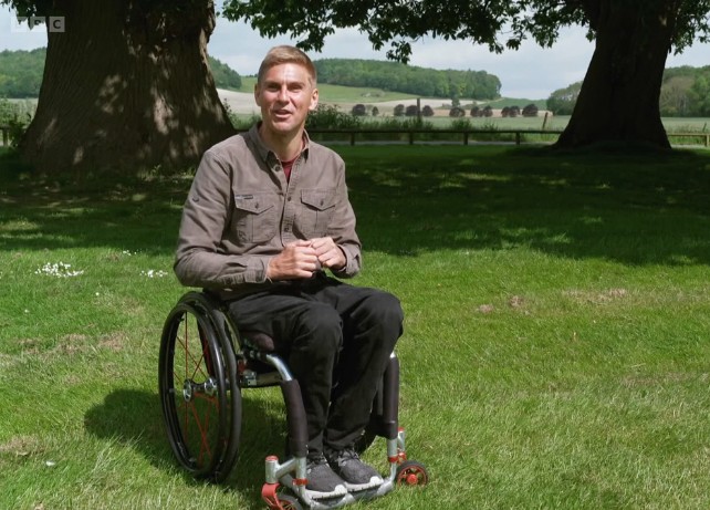 Man sitting in wheelchair in sunny garden