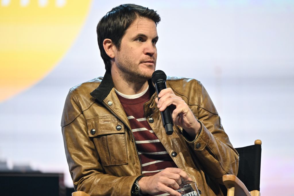 Jamie Linden talking into a microphone