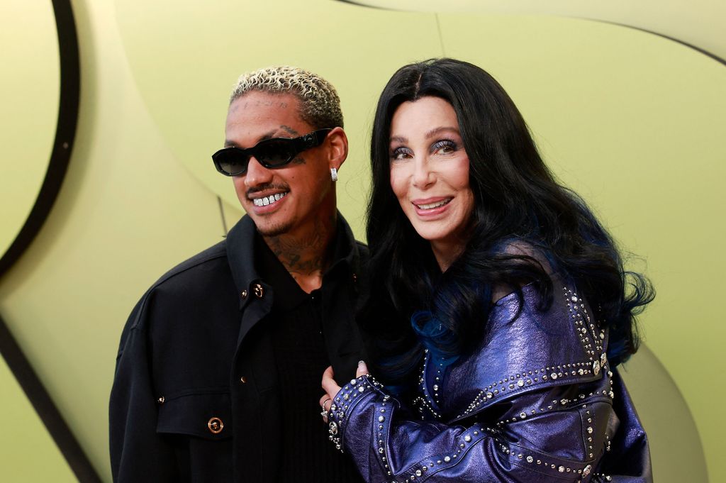 Cher and rapper Alexander Edwards arrive for the Versace Fall/Winter 2023 fashion show on March 9, 2023, at the Pacific Design Center in West Hollywood, California