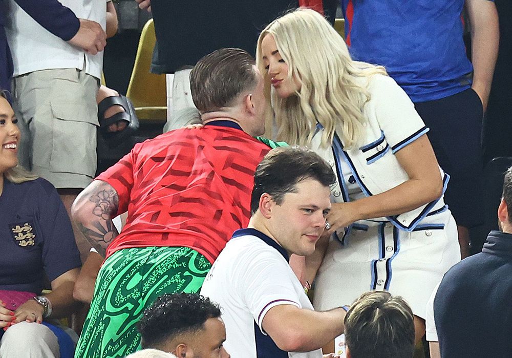 Jordan Pickford and Megan Davison kissing at a Euros football match