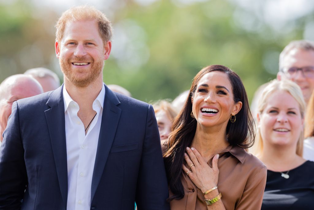 Prince Harry and Meghan Markle smiling in Dusseldorf