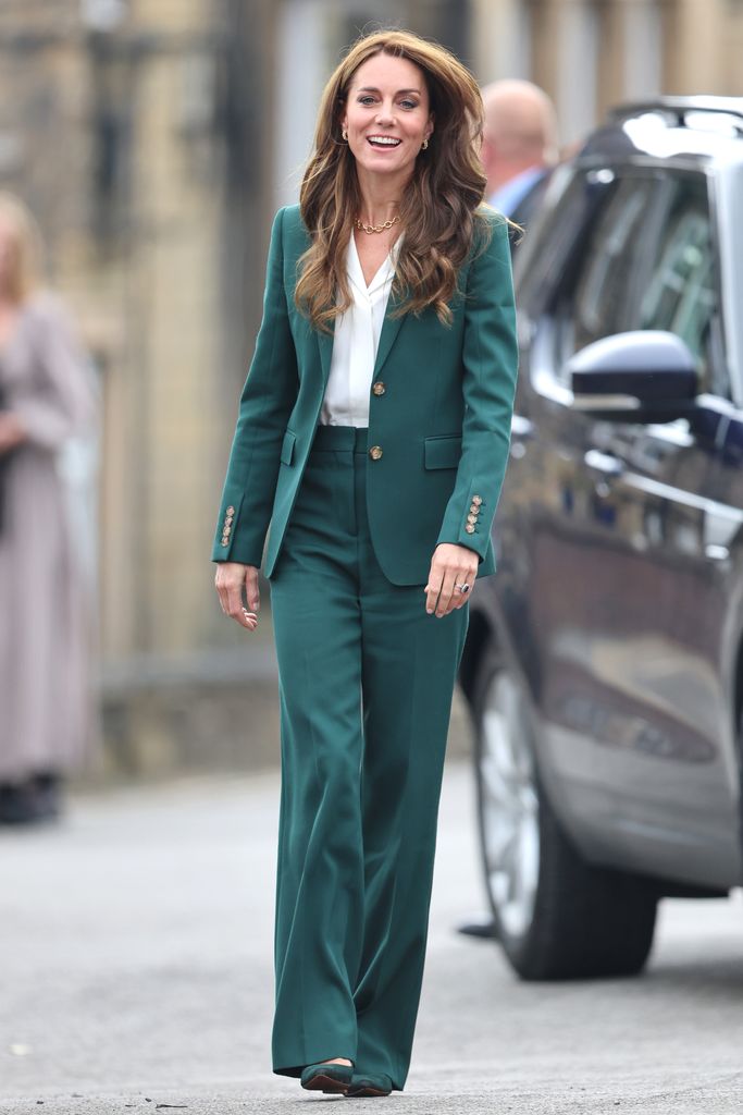 Princess Kate smiles as she arrives for her visit to AW Hainsworth