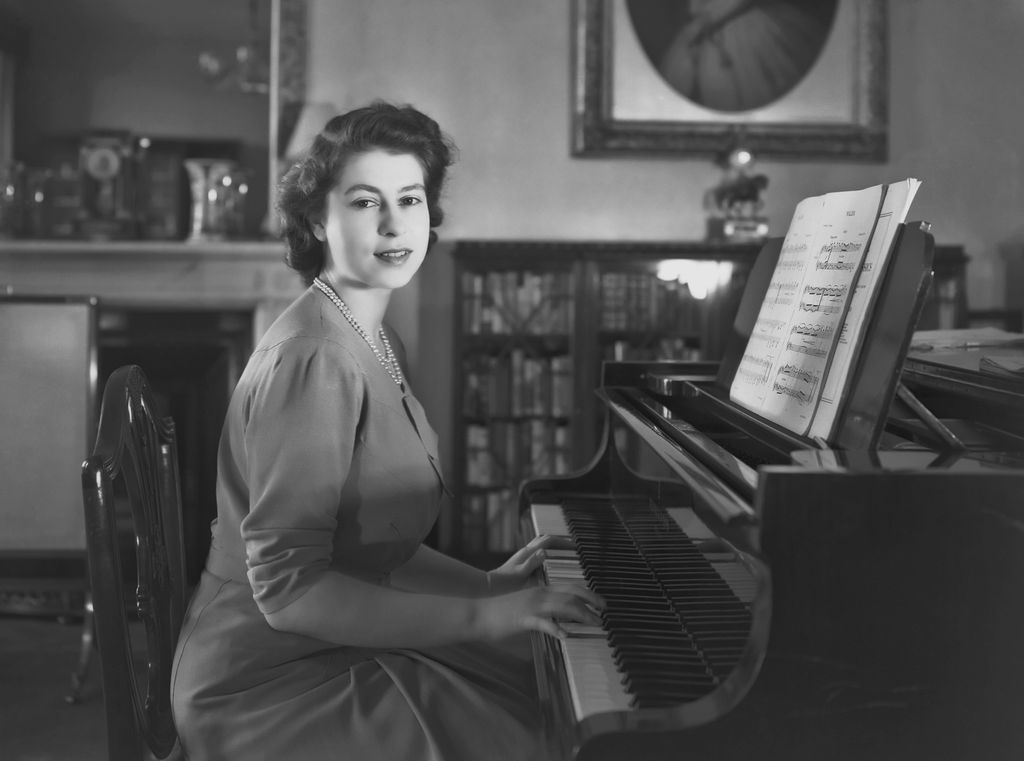 The Queen playing a piano