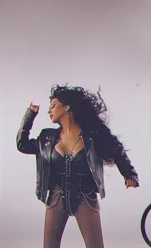 Christina Aguilera in a black corset and leather jacket