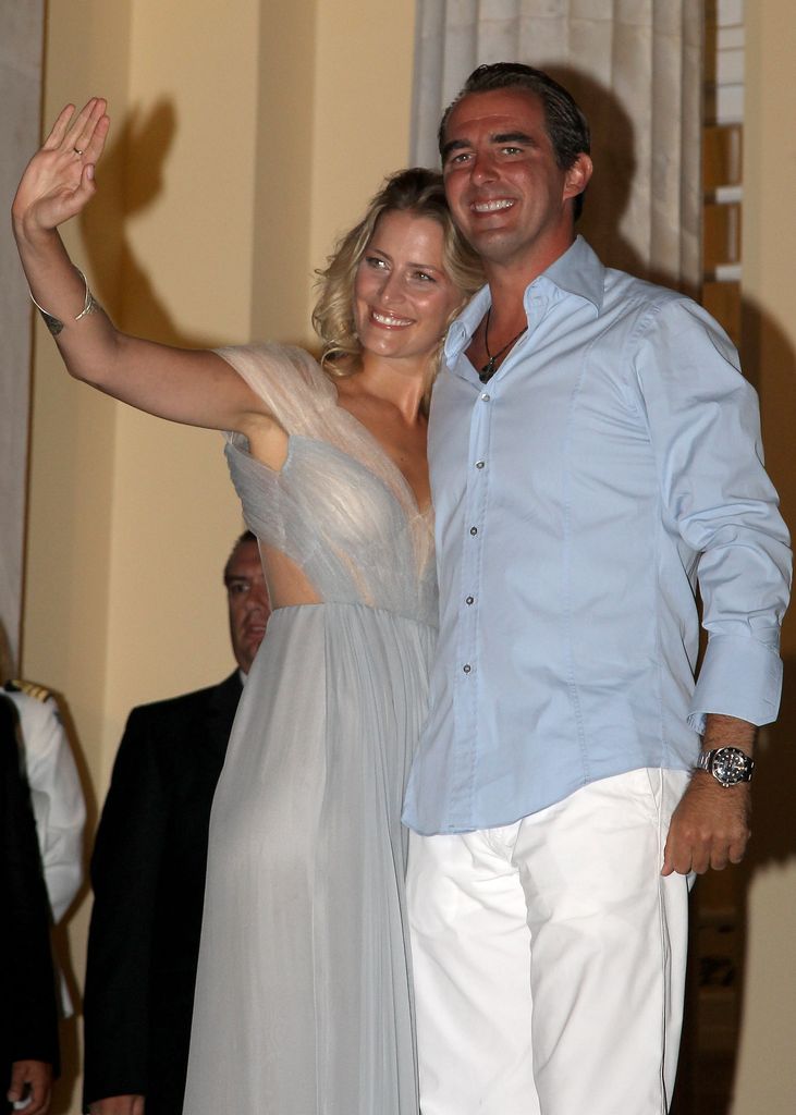 Prince Nikolaos and his fiance Tatiana Blatnik wave from the steps of the Poseidon Hotel as they attend their pre-wedding reception on August 24, 2010 in Spetses, Greece.