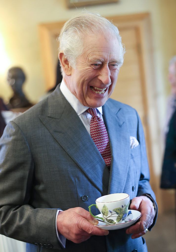 King Charles holds cup of tea at Highgrove tea party