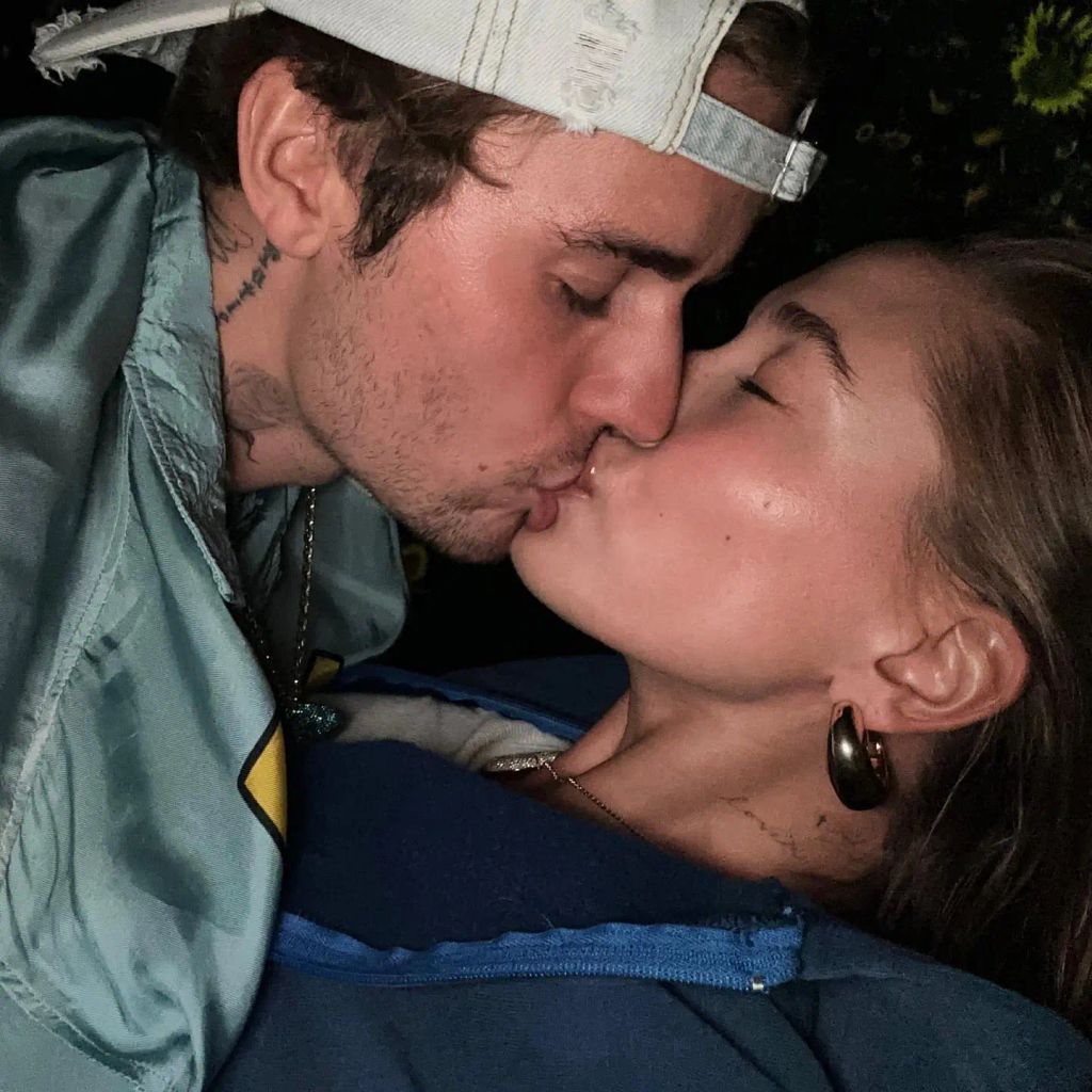 Justin kissing his wife Hailey at Coachella