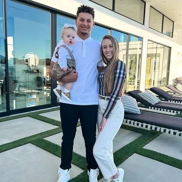 patrick and brittany mahomes holding daughter outside texas house