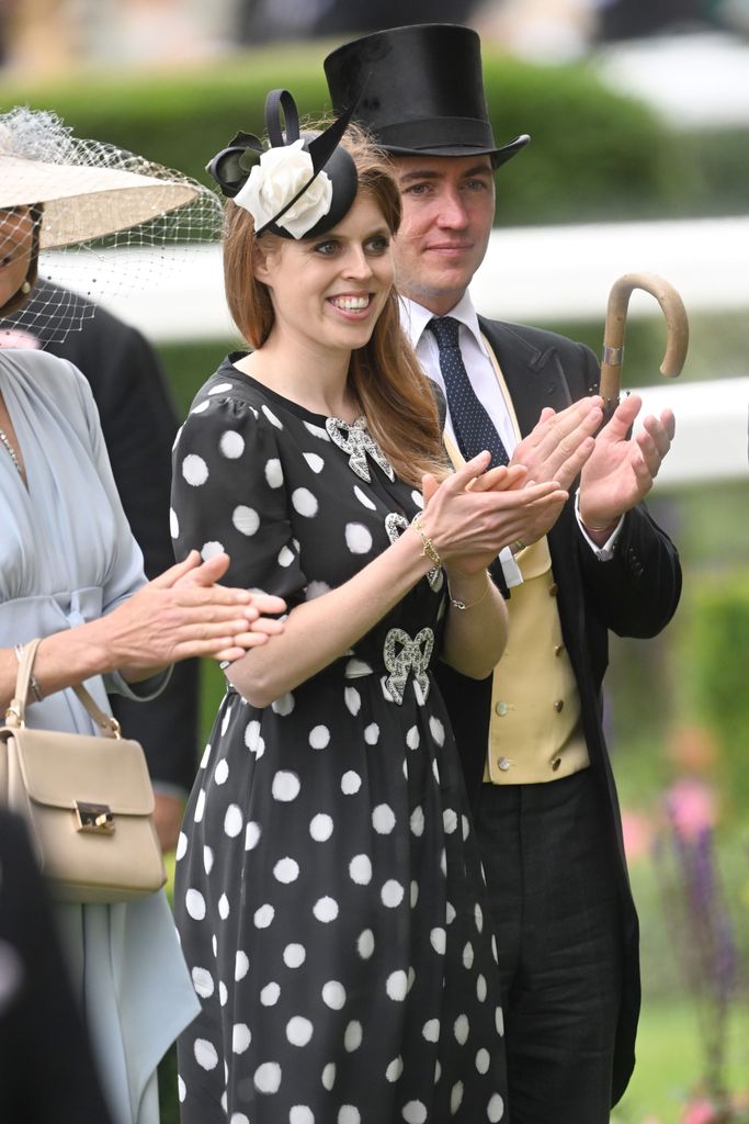 Princess Beatrice in dress featuring bow detailing clapping 