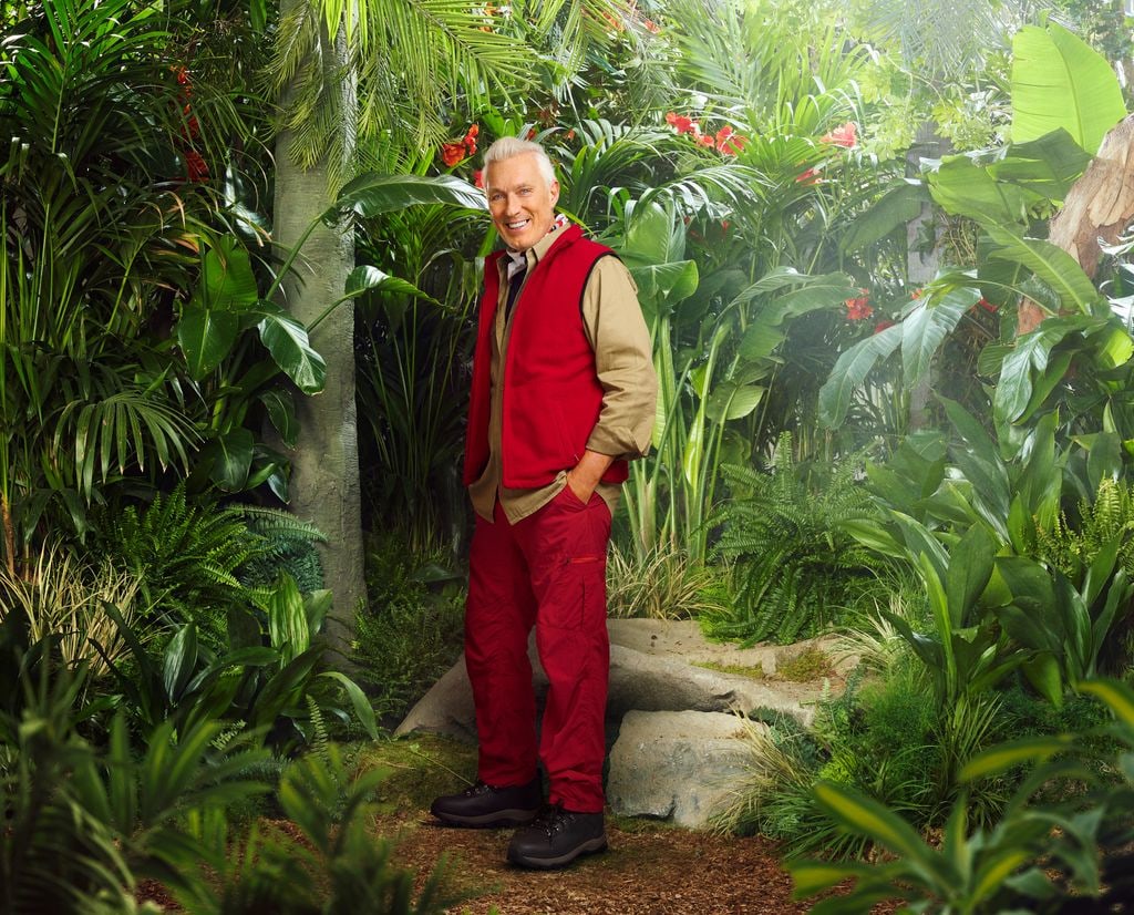 person in red and beige uniform in jungle setting