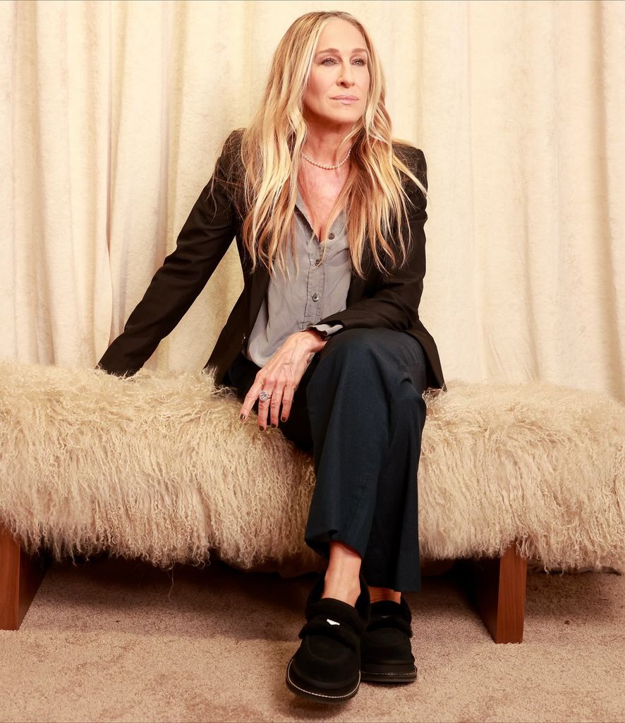 Sarah Jessica Parker on a fluffy bench wearing uggs