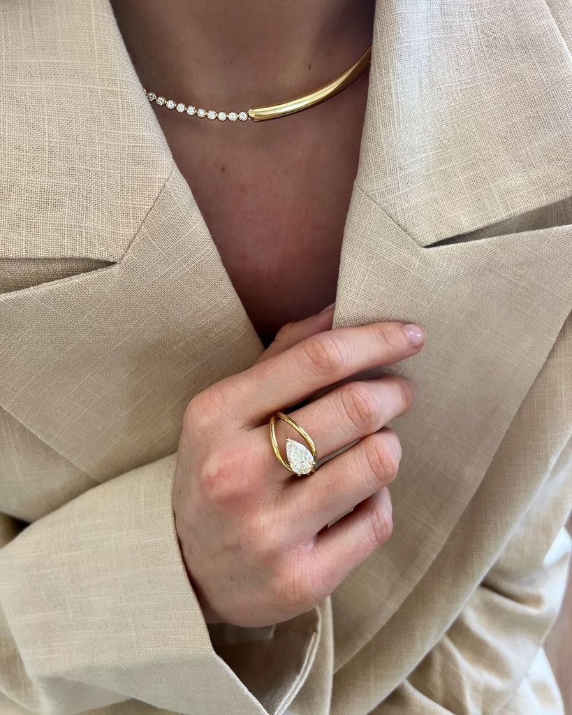 A person wearing a diamond ring and necklace from Kimai Jewellery
