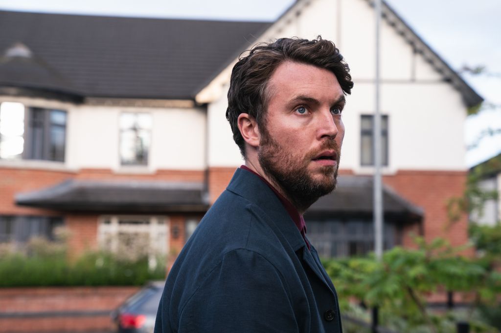 close-up of man with dark hair outside house