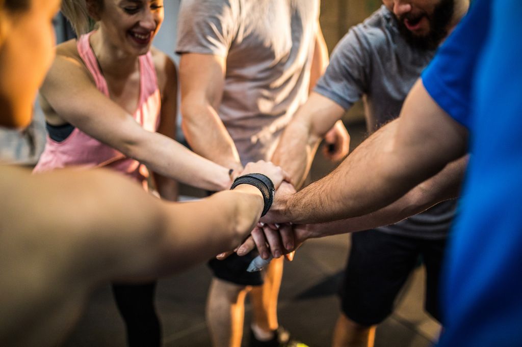 Group Of People Cheering Before Sports Training In Gym