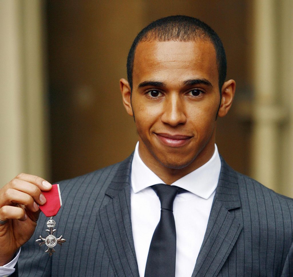 British F1 world champion Lewis Hamilton poses for pictures after receiving the Member of the British Empire (MBE) award from Queen Elizabeth II at Buckingham Palace in central London, on March 10, 2009. AFP PHOTO/Johnny Green/WPA POOL (Photo credit should read JOHNNY GREEN/AFP via Getty Images)