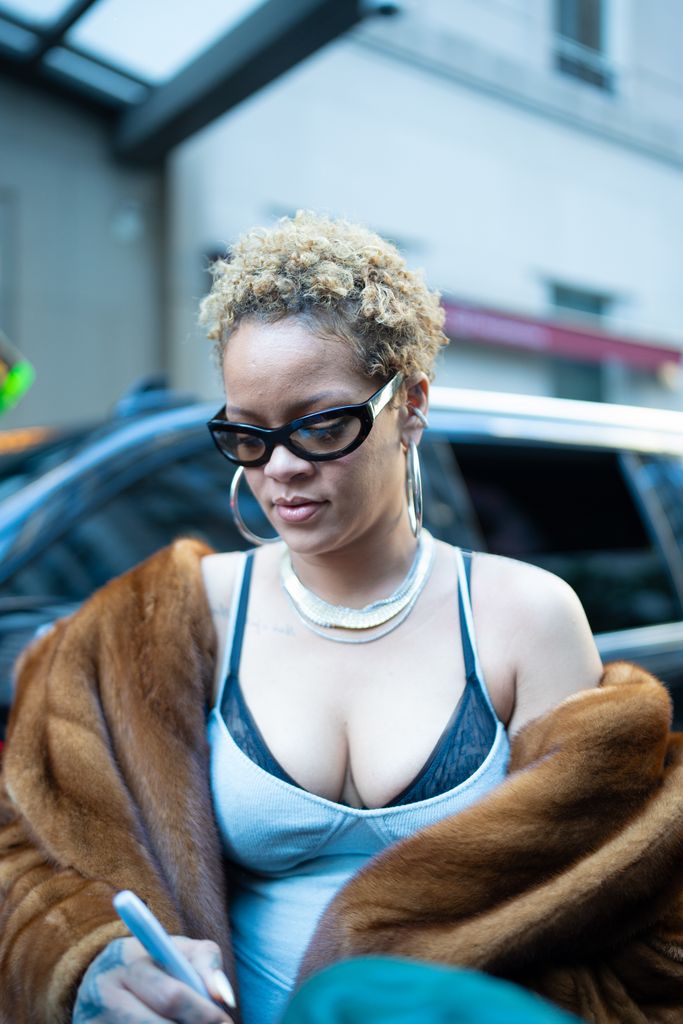 Rihanna turns heads as she exits her New York hotel as she rocks her natural curls