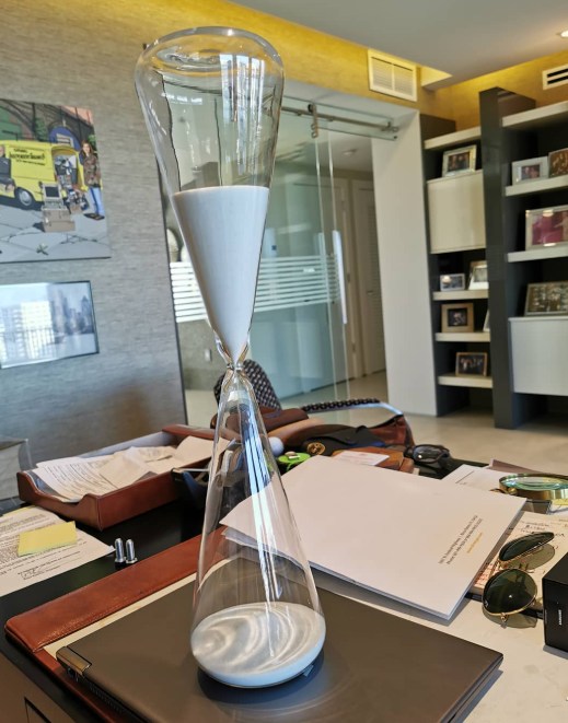 office with sand timer on the desk