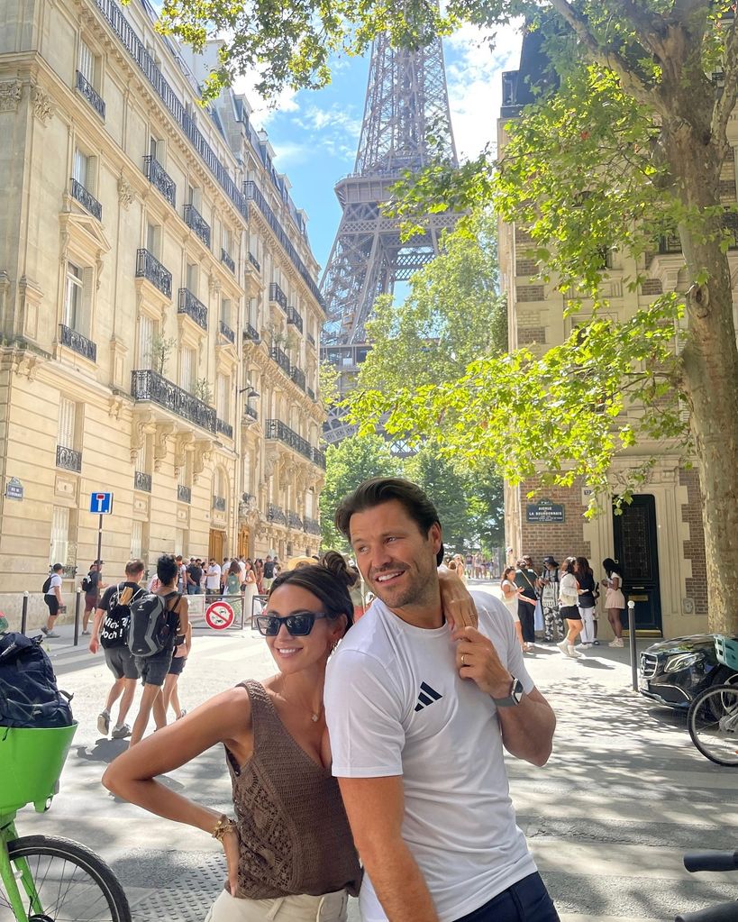 couple posing in front of eiffel tower