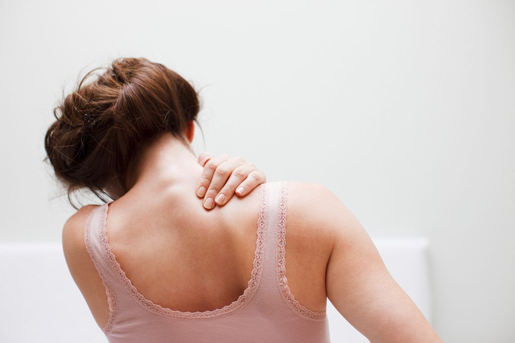 Woman rubbing aching back