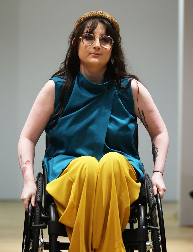 Young woman in a wheelchair on the catwalk at London Fashion Week