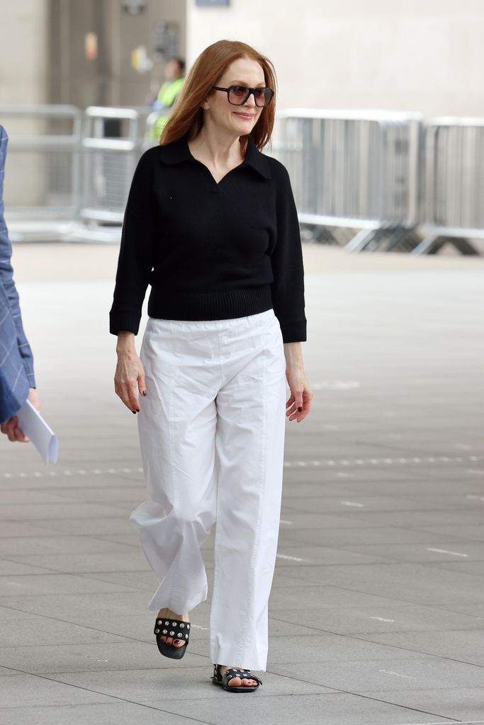 Julianne Moore memamerkan gaya musim panasnya mengenakan sepasang sandal hitam datar bertabur