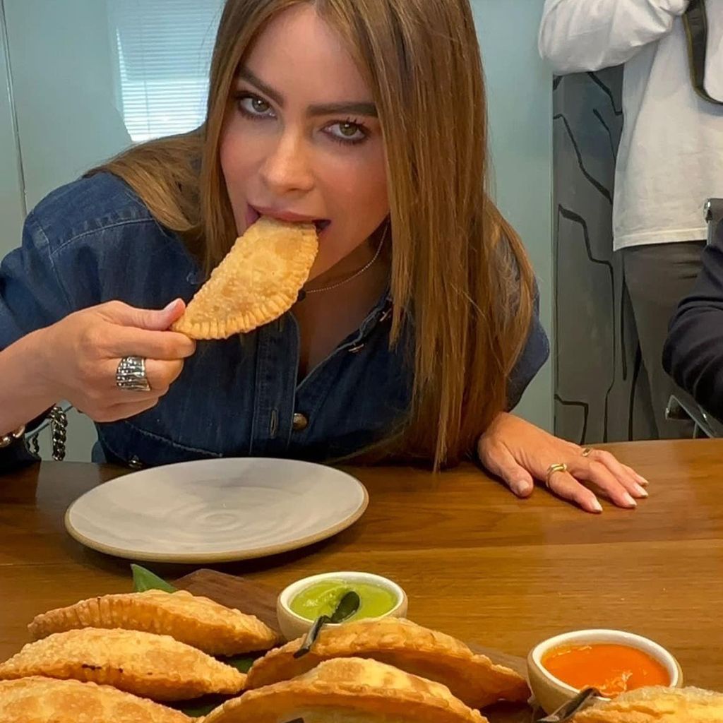 Sofia Vergara eating in a denim shirt