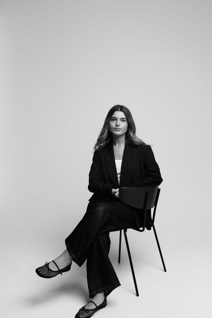Black-and-white portrait of woman in oversized blazer and wide-leg jeans