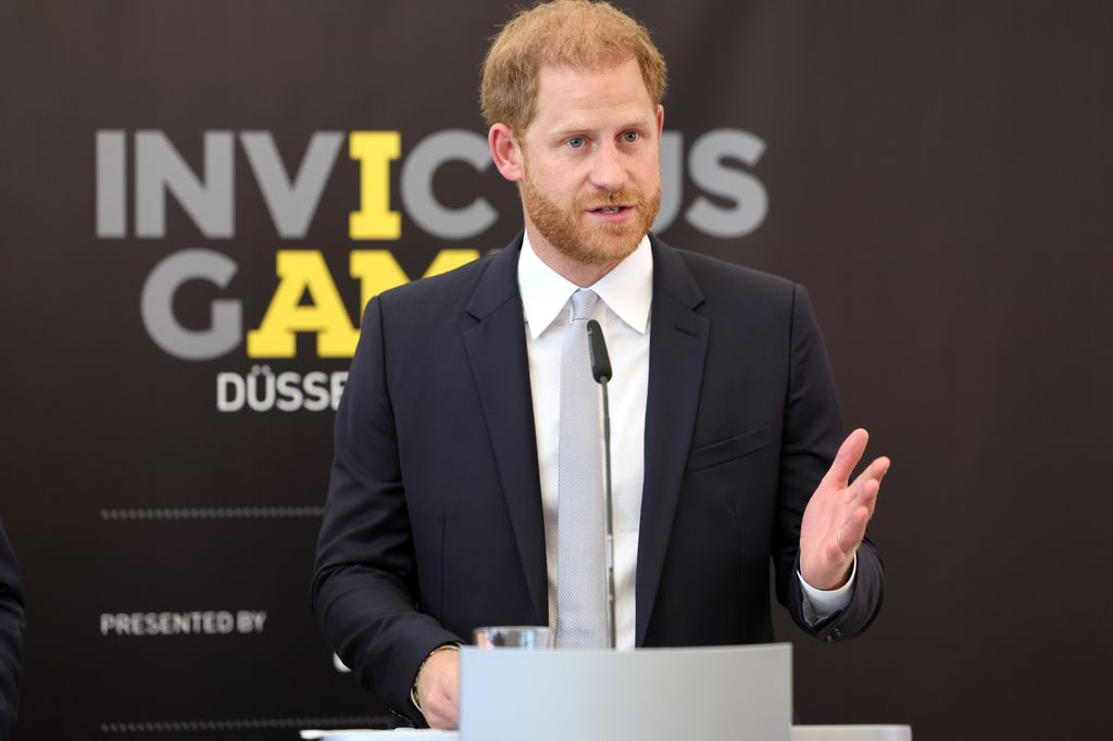 Prince Harry speaking in a black suit