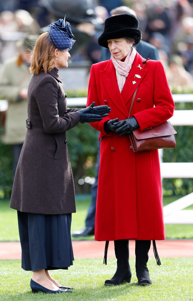 Princess Anne in red coat talking to her lady-in-waiting Dolly Maude