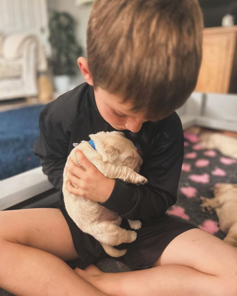 A photo of Helen Skelton's son holding a puppy