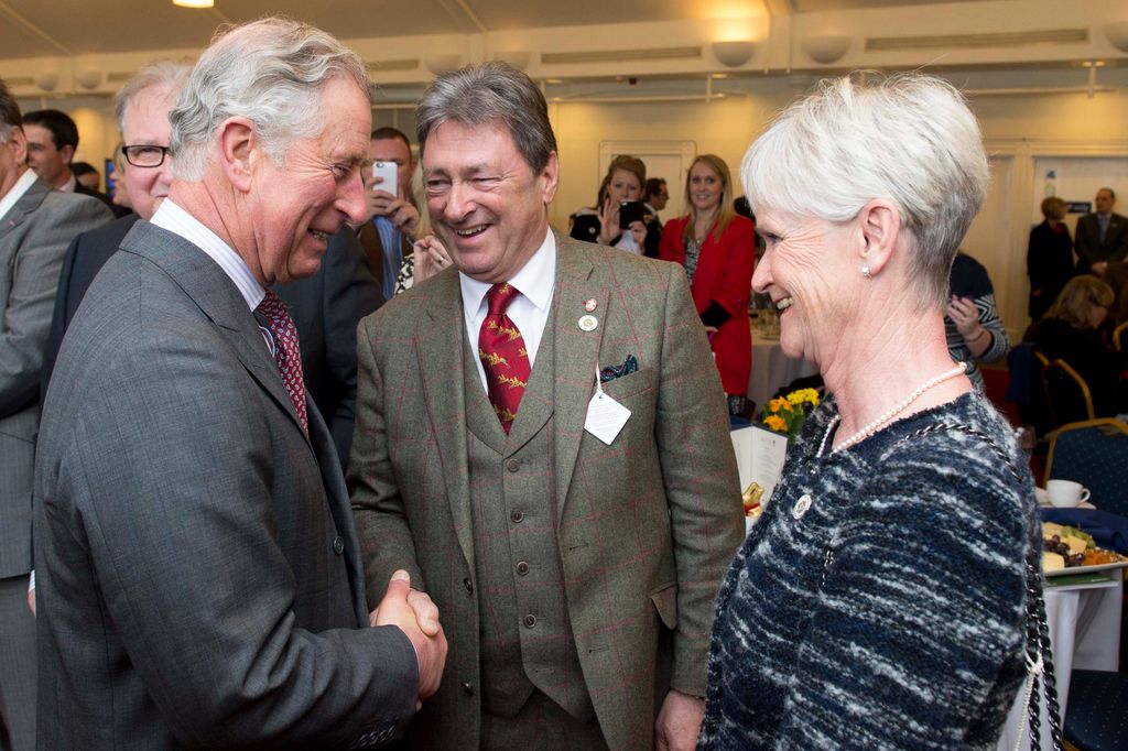 three people chatting at reception 