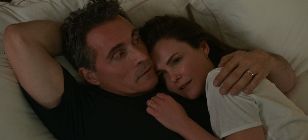 Rufus Sewell and Keri Russell hugging in The Diplomat