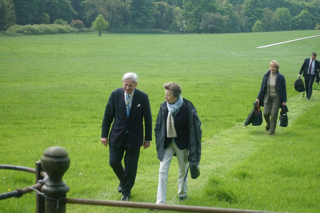 Princess Anne walking in a field in white jeans