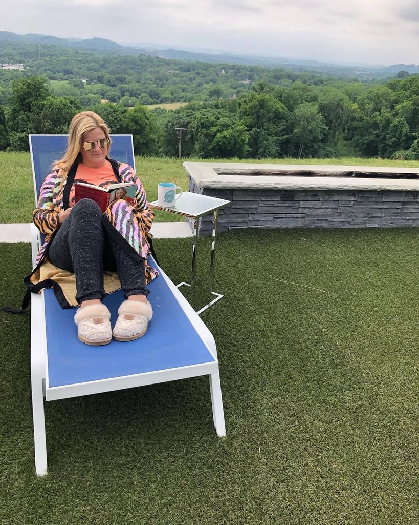 Trisha Yearwood sits on a lounger in her garden