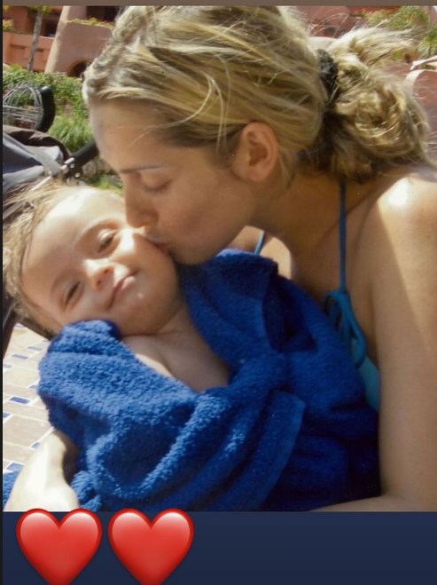 Louise Redknapp kissing her young son Charley, wrapped in a towel