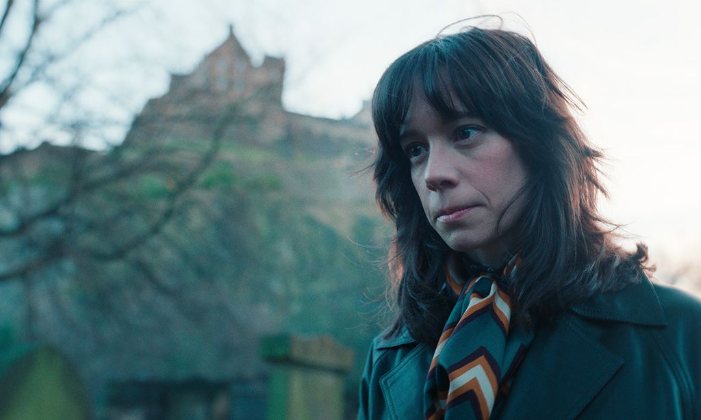 close-up of brunette woman in front of house