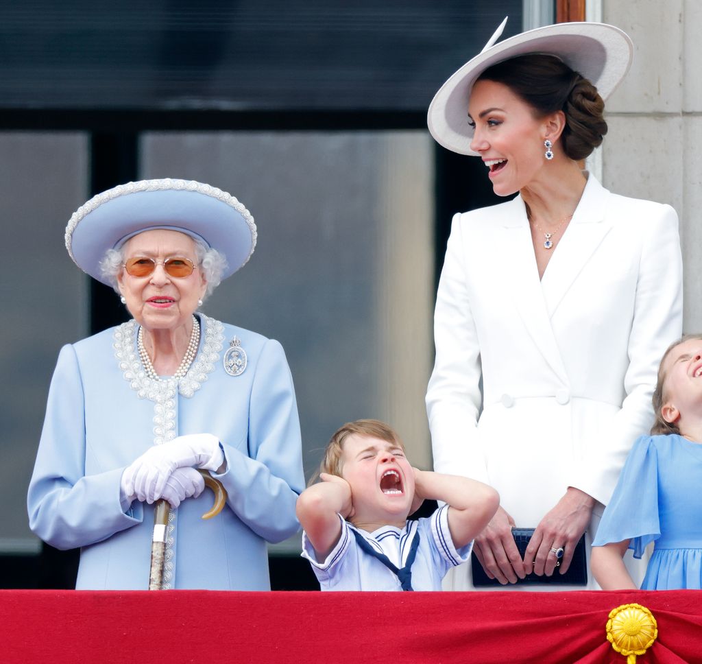 Queen Elizabeth II, Prince Louis of Cambridge and Catherine, Duchess of Cambridge watch a flypast from the balcony of Buckingham Palace during Trooping the Colour