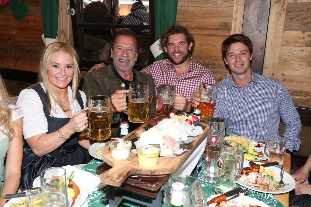 Heather Milligan, Arnold Schwarzenegger, son Christopher Schwarzenegger and son Patrick Schwarzenegger during the 187th Oktoberfest at Marstall tent /Theresienwiese on September 24, 2022 in Munich, Germany