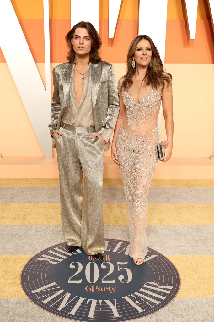 mother and son posing at vanity fair oscar party
