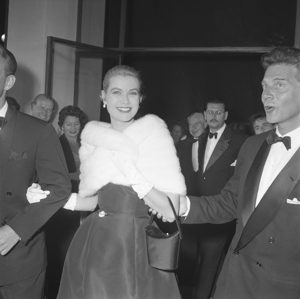 Grace Kelly in a fluffy stole at a party during the Cannes Film Festival 